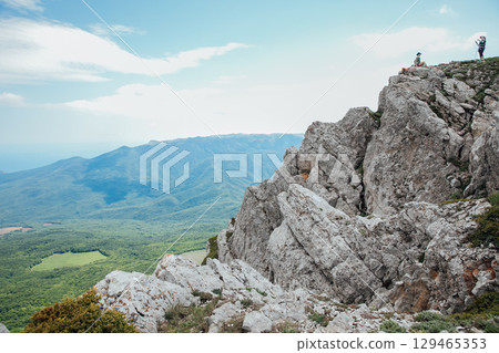 Tourists look at the landscape, mountains and forest Tourists look at the landscape, mountains and forest 129465353