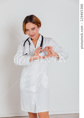 doctor with stethoscope showing heart in hospital 129465366