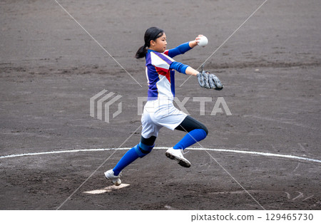 A junior high school girl pitching softball in a club activity 129465730