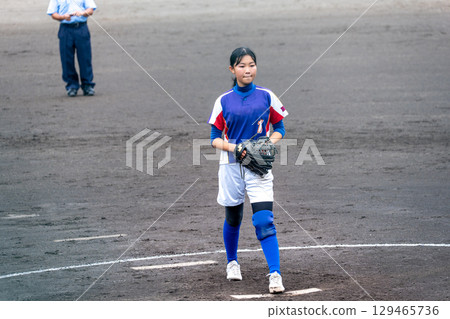 A junior high school girl pitching softball in a club activity A junior high school girl pitching softball in a club activity 129465736