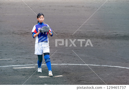 A junior high school girl pitching softball in a club activity 129465737