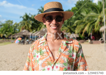 Hispanic Male Tourist in Panama Hat and Tropical Shirt Enjoying Summer Vacation at Beach 129465740
