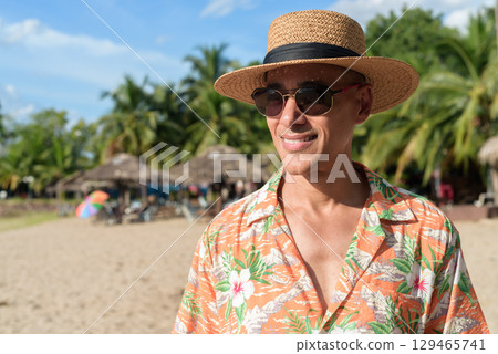 Hispanic Male Tourist in Panama Hat and Tropical Shirt Enjoying Summer Vacation at Beach 129465741