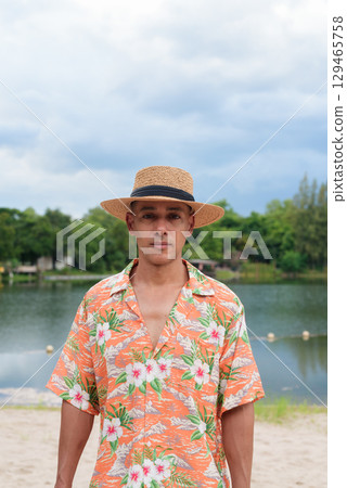 Hispanic Male Tourist in Panama Hat and Tropical Shirt Enjoying Summer Vacation at Beach Hispanic Male Tourist in Panama Hat and Tropical Shirt Enjoying Summer Vacation at Beach 129465758