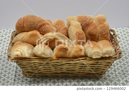 Wicker basket full of freshly baked crescent rolls Wicker basket full of freshly baked crescent rolls 129466002