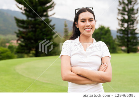 Asian woman in white polo shirt at golf course, on greenery field, tourist outdoor lifestyle Asian woman in white polo shirt at golf course, on greenery field, tourist outdoor lifestyle 129466093
