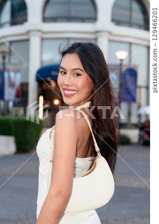 Young Asian woman tourist with long black hair in European style town in portrait travel style Young Asian woman tourist with long black hair in European style town in portrait travel style 129466201