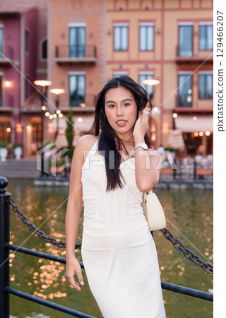Young Asian woman tourist with long black hair in European style town in portrait travel style 129466207