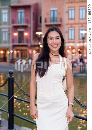 Young Asian woman tourist with long black hair in European style town in portrait travel style Young Asian woman tourist with long black hair in European style town in portrait travel style 129466209