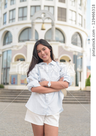 Young Asian woman tourist with long black hair in European style town in portrait travel style Young Asian woman tourist with long black hair in European style town in portrait travel style 129466318