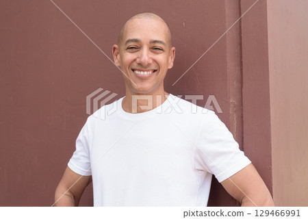 Studio style portrait of happy bald Hispanic man smiling Studio style portrait of happy bald Hispanic man smiling 129466991