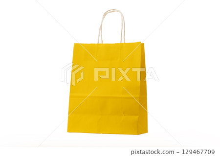 Yellow shopping bag on white background 129467709