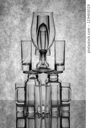Still life with glassware on a reflective surface Still life with glassware on a reflective surface 129468026