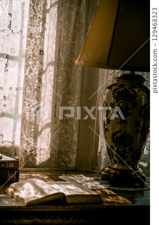 books on the desk by the window books on the desk by the window 129468323