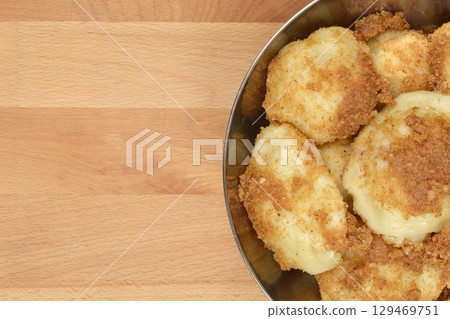 Potato dumplings topped with toasted breadcrumbs Potato dumplings topped with toasted breadcrumbs 129469751