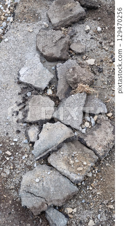 Broken asphalt and rocks Broken asphalt and rocks 129470256