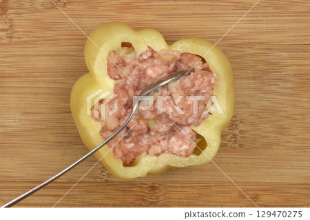 Raw pepper being stuffed 129470275