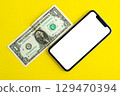 Mockup, smartphone and dollar on yellow background. 129470394