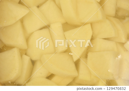 Chopped potatoes submerged in water Chopped potatoes submerged in water 129470832