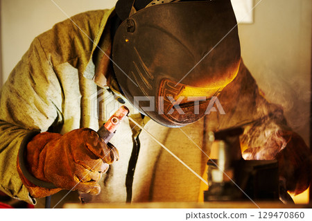 Close-up image of industrial worker at the factory welding. Close-up image of industrial worker at the factory welding. 129470860