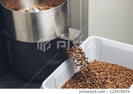Freshly Roasted Coffee Beans Pouring From Cooling Hopper Into Container Freshly Roasted Coffee Beans Pouring From Cooling Hopper Into Container 129470876