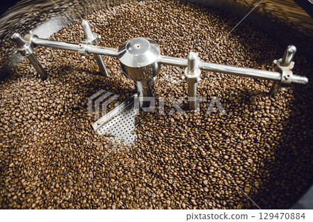 Cooling Drum of Coffee Roaster With Freshly Roasted Beans at Local Personal Roasting Factory, Overhead View Cooling Drum of Coffee Roaster With Freshly Roasted Beans at Local Personal Roasting Factory, Overhead View 129470884