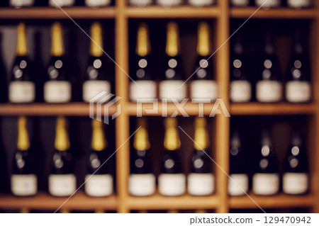 Blurred Frontal View of Wine Shelves with Sparkling Wine Blurred Frontal View of Wine Shelves with Sparkling Wine 129470942