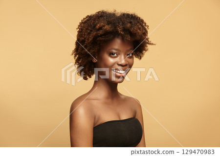 Happy young female model with dark ideal soft skin smiling. Happy young female model with dark ideal soft skin smiling. 129470983