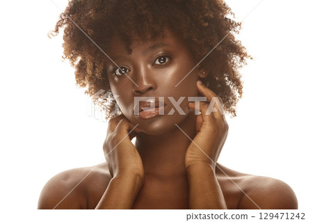 African american girl touching her soft flawless skin on face. 129471242