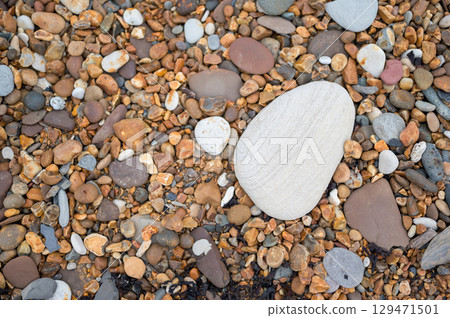 Smooth pebbles on the beach, abstract natural rocks background 129471501