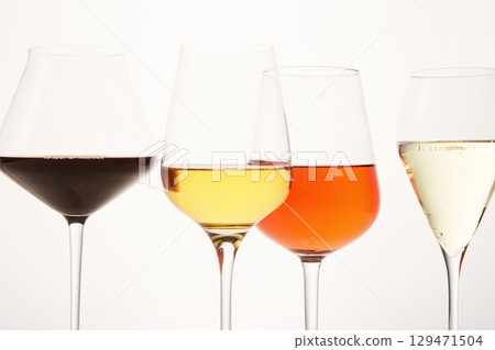 Pink, white, red, sparkling alcoholic drinks in wine glasses. Pink, white, red, sparkling alcoholic drinks in wine glasses. 129471504