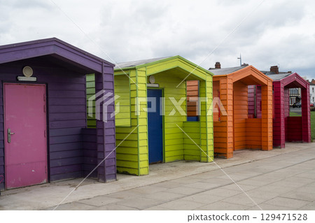 Colorful beach huts on a seaside beach, u.k. Colorful beach huts on a seaside beach, u.k. 129471528
