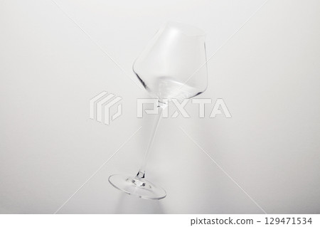 Empty transparent glass on thin stem for wine. 129471534