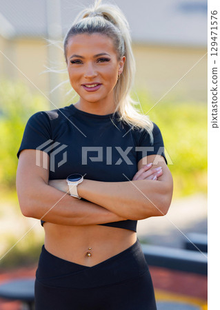 Active woman showcasing fitness outdoors with wearable technology and confident posture Active woman showcasing fitness outdoors with wearable technology and confident posture 129471576