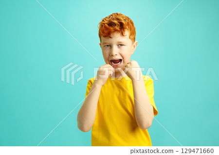 Handsome Little Boy Cleaning His Teeth with a Dental Floss on Blue Isolated. Handsome Little Boy Cleaning His Teeth with a Dental Floss on Blue Isolated. 129471660
