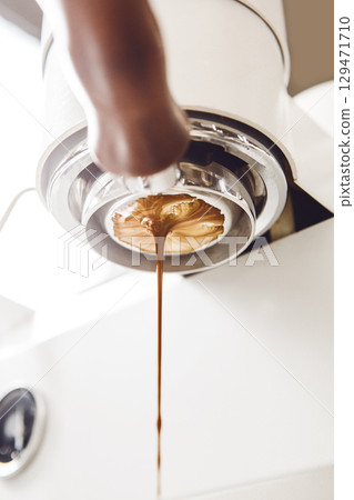 Freshly Brewed Espresso Flowing From Coffee Machine  129471710