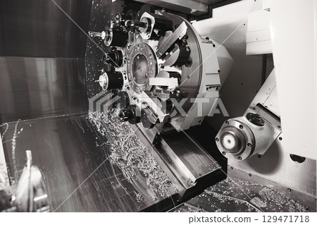 Tool Drum Revolving Lathe Fragment CNC Lathe Revolver Fixed Tools. Cutting groove of turning and milling machine on a metal shaft. High-tech manufacturing process of parts on a CNC lathe. Tool Drum Revolving Lathe Fragment CNC Lathe Revolver Fixed Tools. Cutting groove of turning and milling machine on a metal shaft. High-tech manufacturing process of parts on a CNC lathe. 129471718