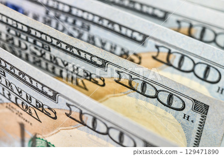 Background of US dollar bills. Pile of american cash. One hundred usd dollars banknotes 129471890