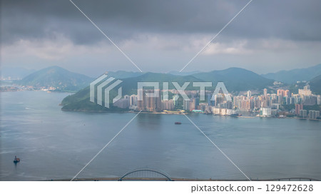 July 12 2025 Scenic City Skyline with Hills Surrounding Tranquil Waterfront Area 129472628