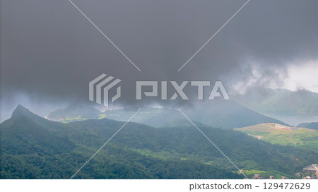 July 12 2021 View of Lush Green Hills Underneath a Dramatic Overcast Sky 129472629