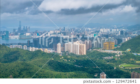 July 12 2025 Urban Skyline of Hong Kong Surrounded by Lush Forested Hills and Sea 129472641