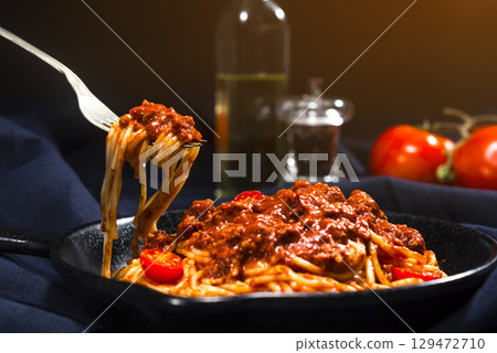 Spaghetti with bolognese on a fork. 129472710