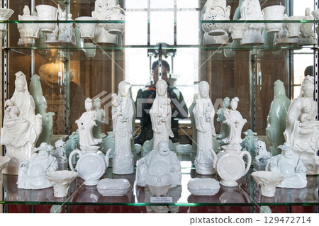 The Blanc de Chine porcelain figurines, beautifully crafted in white, depict figures like the Goddess of Mercy, Guanyin, symbolizing Chinese spirituality and cultural heritage. The Blanc de Chine porcelain figurines, beautifully crafted in white, depict figures like the Goddess of Mercy, Guanyin, symbolizing Chinese spirituality and cultural heritage. 129472714