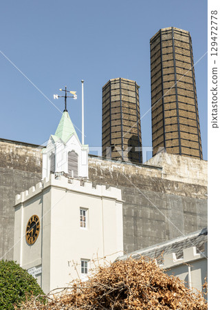 The white building in the foreground is Trinity Hospital with rectangular structures in the background are part of Greenwich Power Station. 129472778