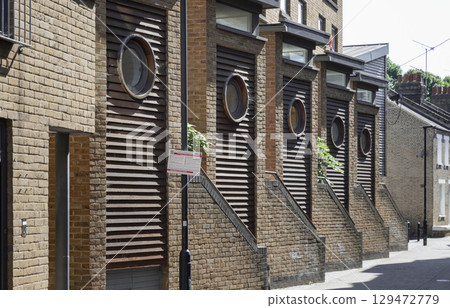 The Porthole Houses, Apartments and housing are indeed characterized by their distinctive porthole-shaped windows and slatted wooden facades. 129472779