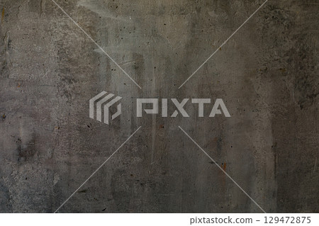 Decorative shabby dark-grey plastered wall with scratches, art background, copy space. 129472875