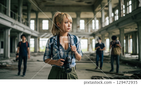 Young woman taking photos in ruins 129472935
