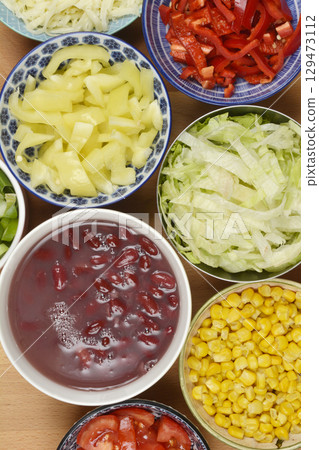 assortment of fresh chopped vegetables and shredded chesse assortment of fresh chopped vegetables and shredded chesse 129473112