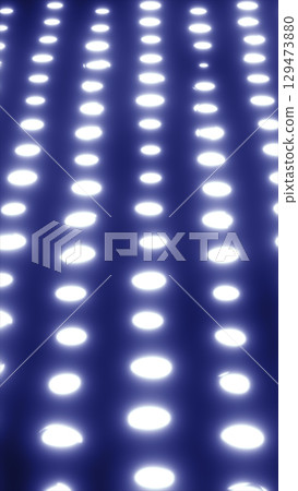 Abstract glowing rows of bright white dots fading into a dark background Abstract glowing rows of bright white dots fading into a dark background 129473880
