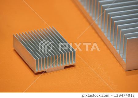 The aluminum heat sink parts on the orange background. 129474012
